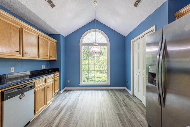 kitchen featuring visible vents, dishwasher, stainless steel refrigerator with ice dispenser, and wood finished floors