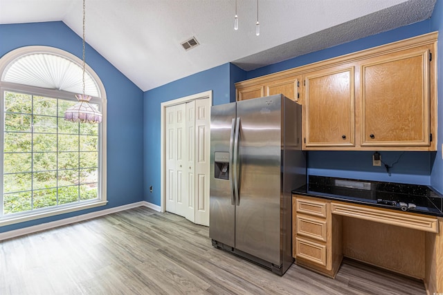 409 65th Ave N, Myrtle Beach, SC 29572 - kitchen with stainless steel fridge with ice dispenser, lofted ceiling, plenty of natural light, light wood finished floors, and decorative light fixtures