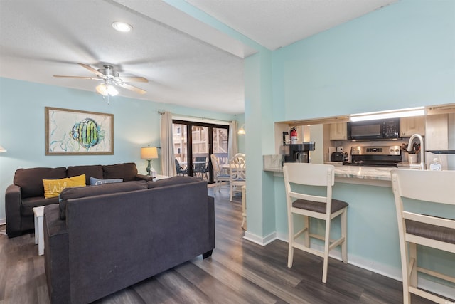 9661 Shore Dr Unit A-21, Myrtle Beach, SC 29572 - living area featuring dark wood-style floors, a ceiling fan, and baseboards