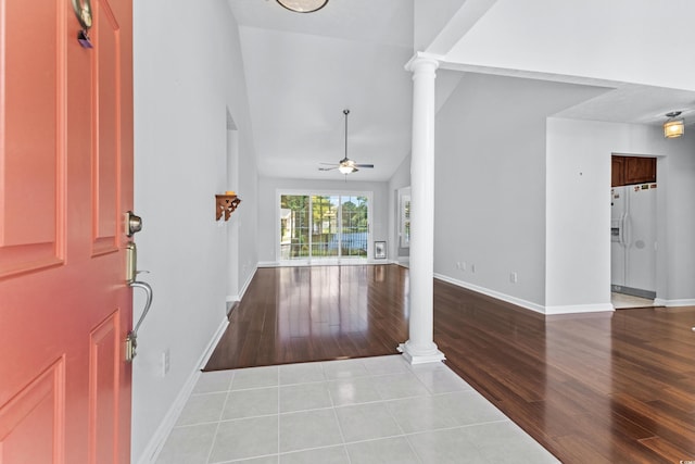 entrance foyer with wood finished floors, decorative columns, a ceiling fan, and baseboards