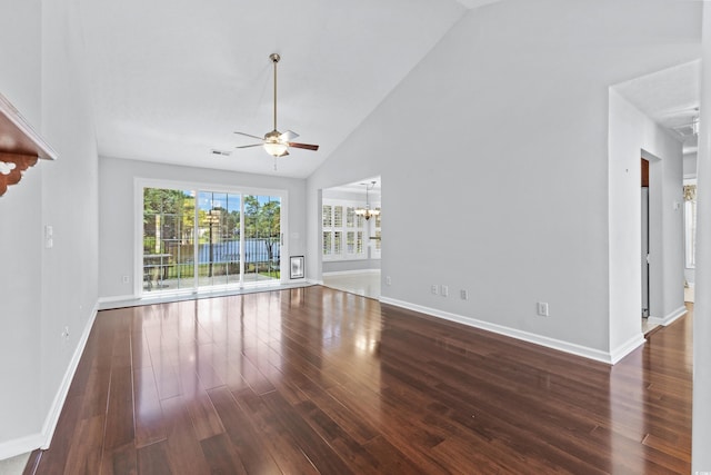 unfurnished living room with wood finished floors, ceiling fan with notable chandelier, visible vents, and baseboards