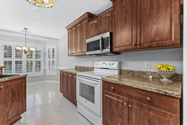 kitchen with electric range, decorative light fixtures, stainless steel microwave, a textured ceiling, and a chandelier