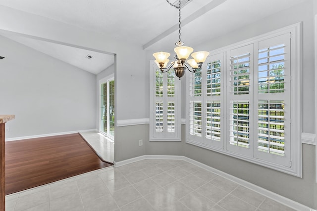 unfurnished dining area featuring visible vents, vaulted ceiling with beams, baseboards, a chandelier, and tile patterned floors