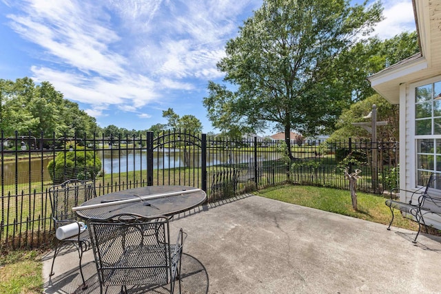 view of patio with a water view, area for grilling, and fence