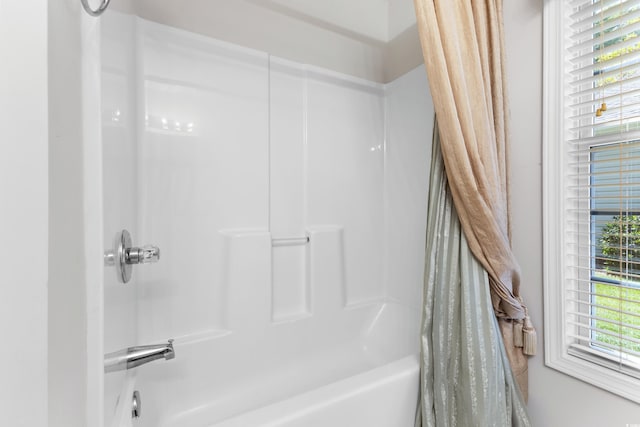 bathroom with shower / bath combination with curtain