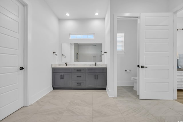 full bath with recessed lighting, toilet, baseboards, and double vanity