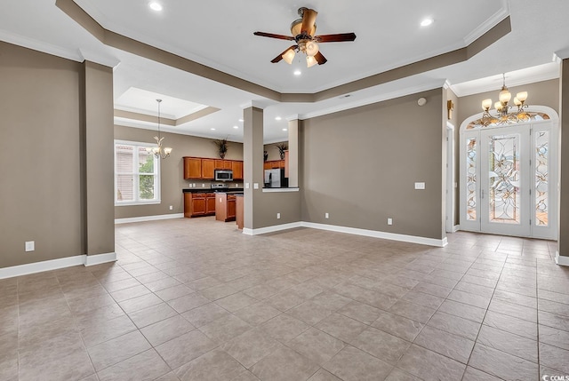 unfurnished living room featuring a raised ceiling, a chandelier, crown molding, recessed lighting, and ceiling fan