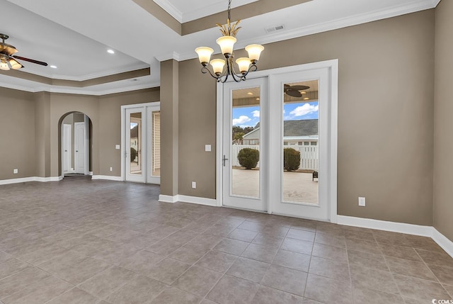 tiled spare room with baseboards, a tray ceiling, arched walkways, ornamental molding, and ceiling fan with notable chandelier