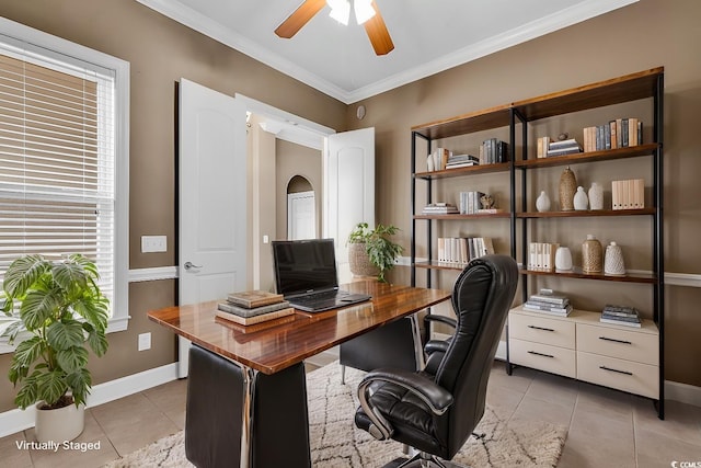office space featuring light tile patterned floors, arched walkways, ceiling fan, baseboards, and crown molding