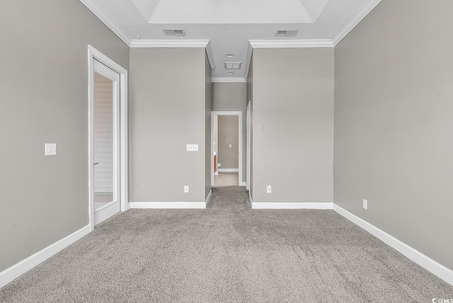 unfurnished bedroom with carpet floors, visible vents, baseboards, and ornamental molding