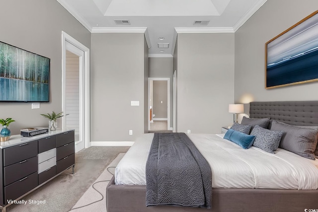 bedroom with carpet, crown molding, baseboards, and ensuite bath