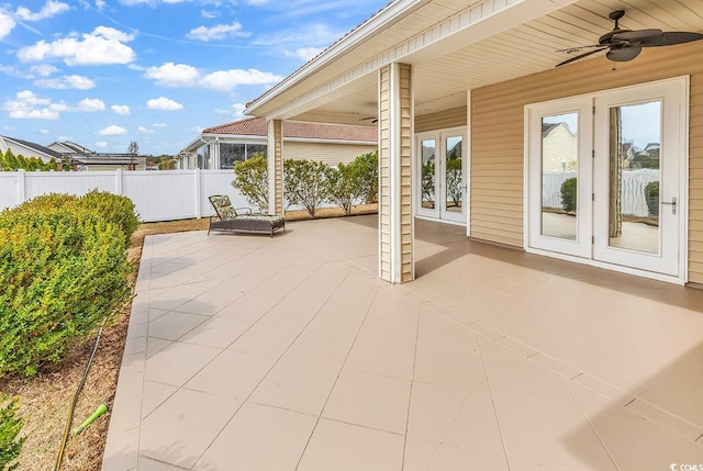 view of patio featuring french doors, a ceiling fan, and fence