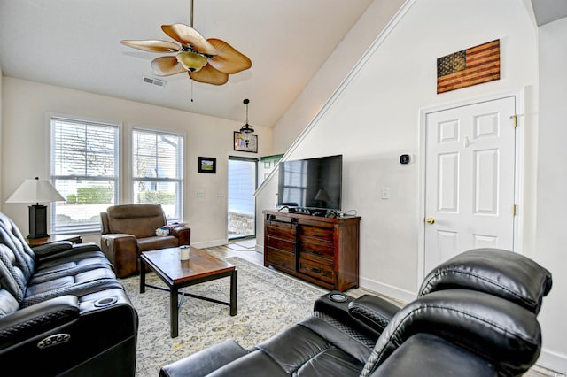 living room with visible vents, baseboards, lofted ceiling, and a ceiling fan