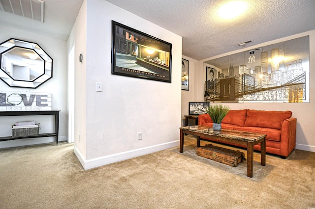 carpeted living area with baseboards, visible vents, and a textured ceiling