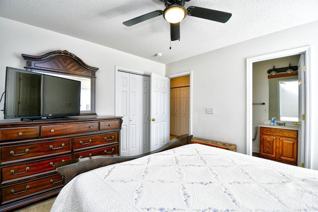 bedroom with a sink, ensuite bathroom, a textured ceiling, and a ceiling fan