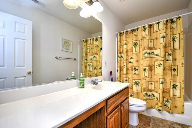 bathroom featuring vanity, shower / bathtub combination with curtain, visible vents, tile patterned floors, and toilet