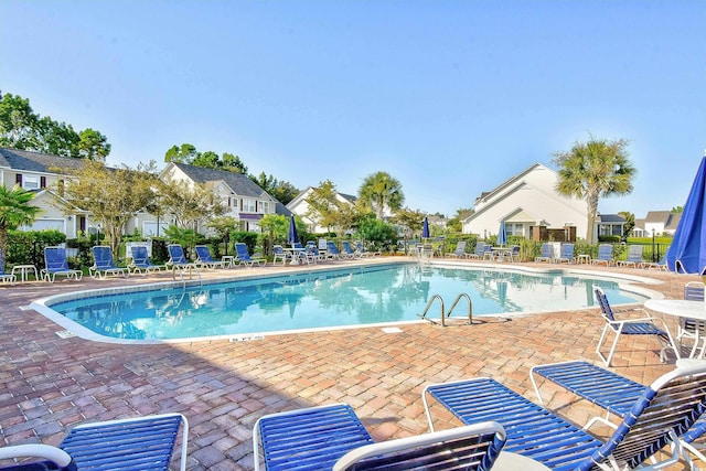 community pool featuring a patio area and fence