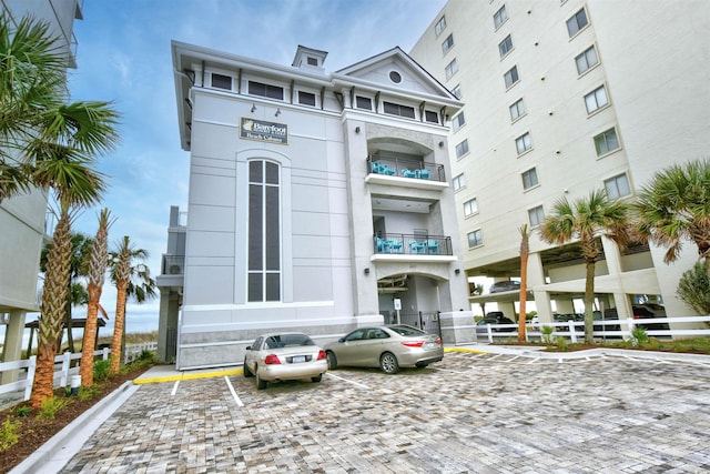 view of building exterior featuring uncovered parking