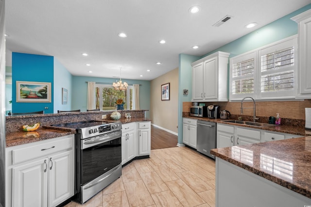 kitchen featuring visible vents, white cabinets, appliances with stainless steel finishes, and a sink