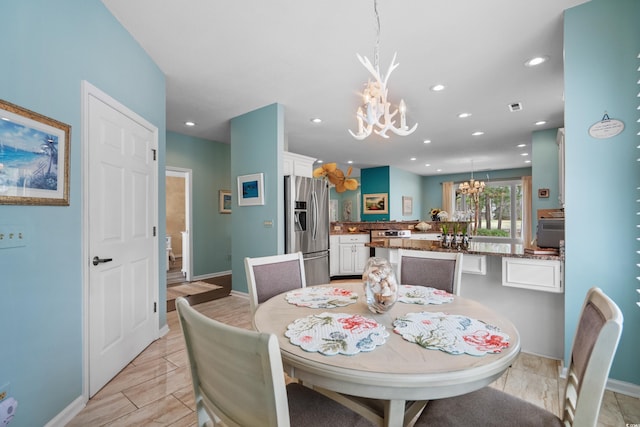 dining area with an inviting chandelier, recessed lighting, and baseboards