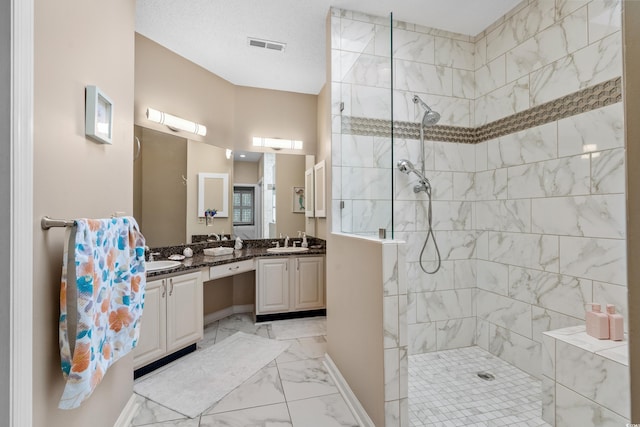 bathroom with visible vents, double vanity, a sink, a walk in shower, and marble finish floor