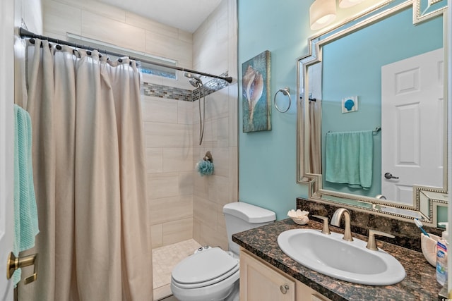 full bathroom with tiled shower, toilet, and vanity