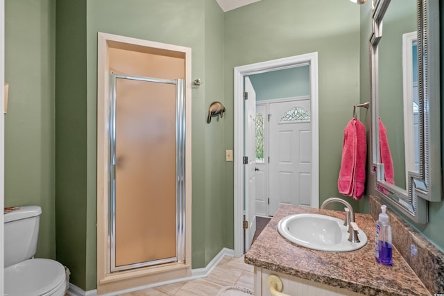 full bathroom with vanity, a shower stall, toilet, and baseboards