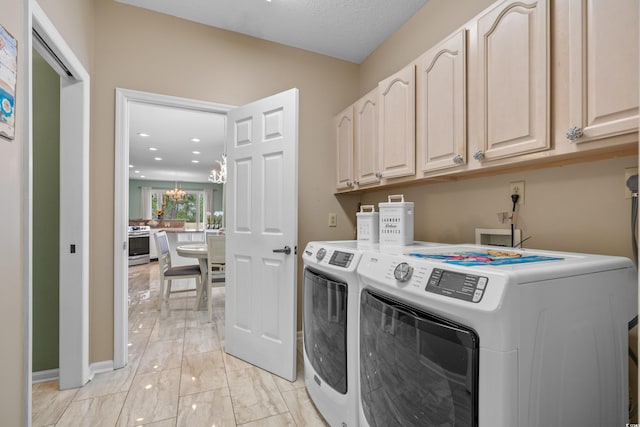 washroom with marble finish floor, independent washer and dryer, cabinet space, an inviting chandelier, and baseboards