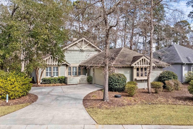 view of front of house featuring concrete driveway and an attached garage