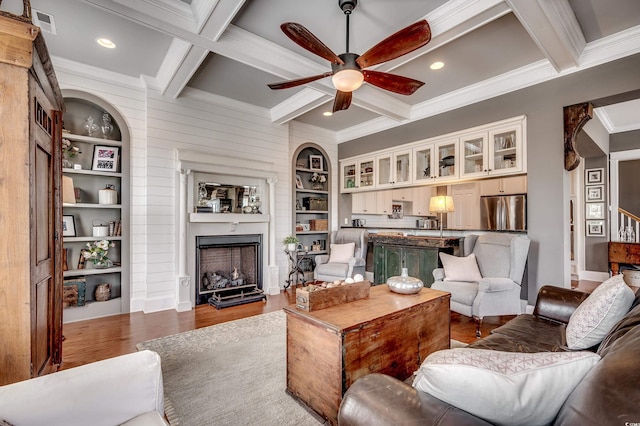 living area featuring built in features, dark wood-style floors, coffered ceiling, beam ceiling, and a fireplace