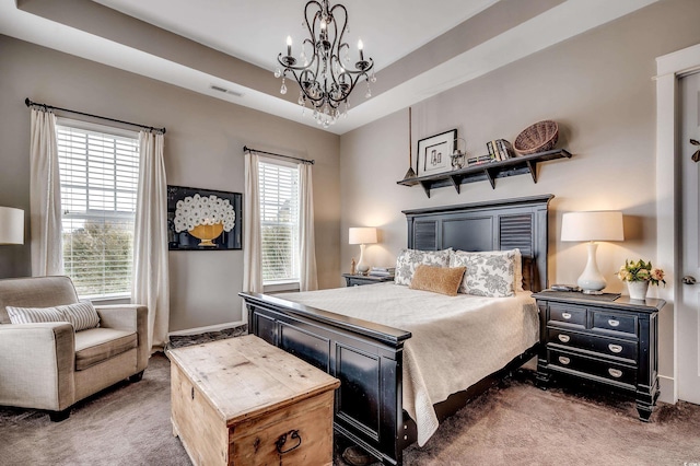 carpeted bedroom featuring a chandelier, visible vents, and a raised ceiling