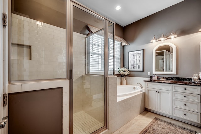 bathroom with a stall shower, recessed lighting, tile patterned flooring, a bath, and vanity