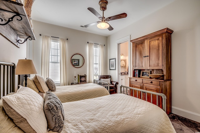 bedroom featuring visible vents, baseboards, and a ceiling fan