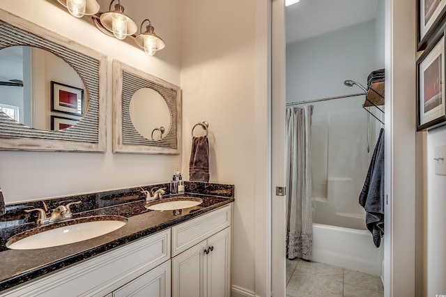 bathroom with a sink, shower / bath combo with shower curtain, double vanity, and tile patterned flooring