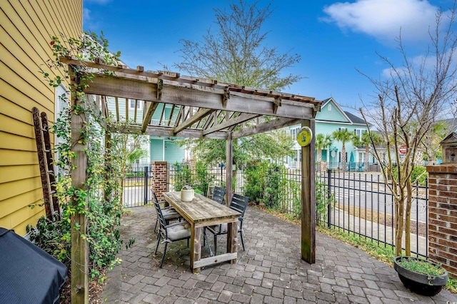 view of patio featuring fence, outdoor dining space, and a pergola