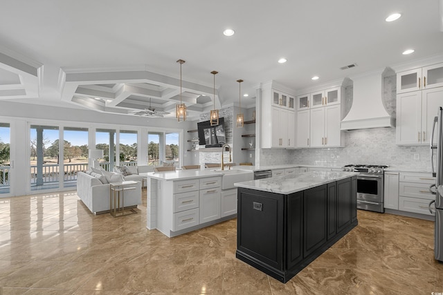 kitchen featuring custom range hood, a peninsula, appliances with stainless steel finishes, a ceiling fan, and a sink