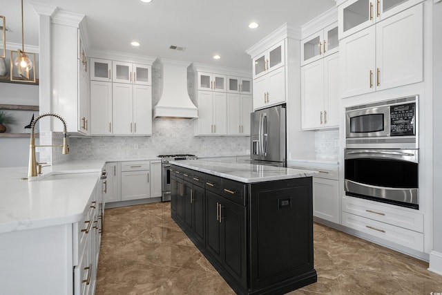 kitchen with a sink, dark cabinetry, appliances with stainless steel finishes, white cabinets, and custom exhaust hood