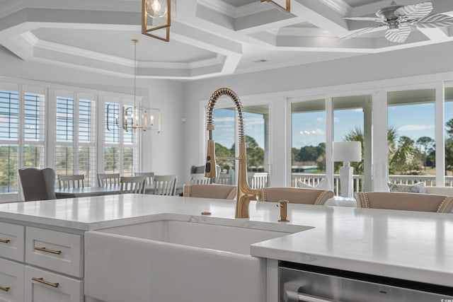 kitchen featuring ceiling fan with notable chandelier, dishwasher, ornamental molding, and a sink