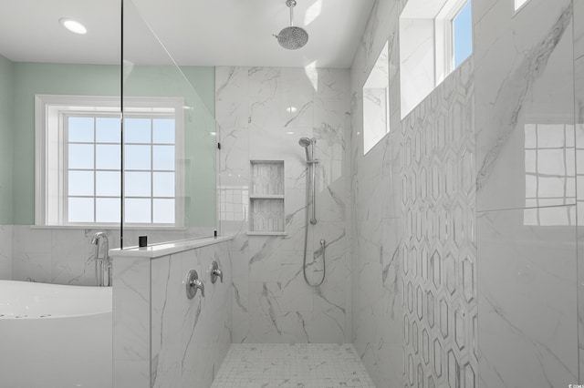 full bathroom featuring a marble finish shower and a freestanding tub