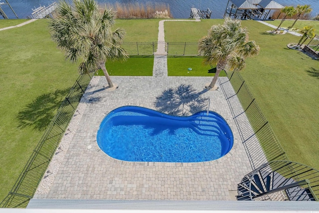 view of pool featuring a lawn, a patio, a fenced backyard, and a fenced in pool