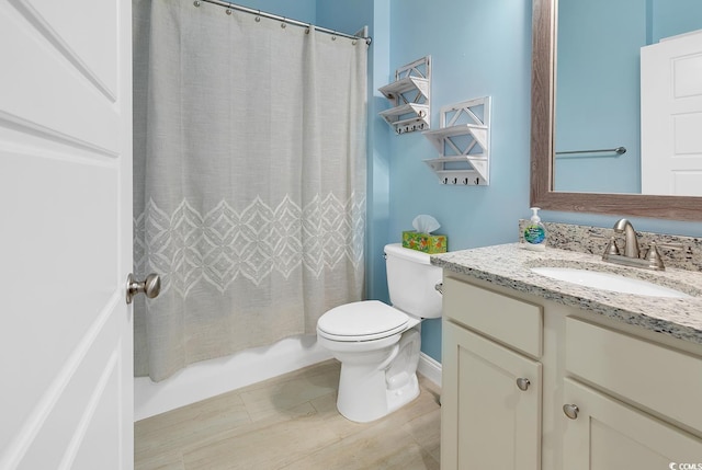 bathroom featuring toilet, vanity, and shower / bath combination with curtain