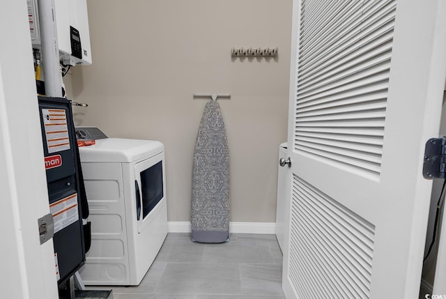 laundry room with baseboards, washing machine and dryer, and laundry area