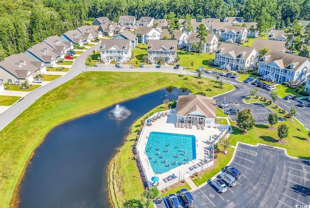 drone / aerial view with a water view and a residential view