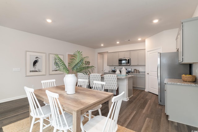 dining space featuring dark wood finished floors, recessed lighting, and baseboards