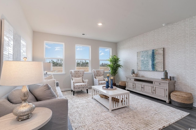 living room featuring baseboards, wood finished floors, wallpapered walls, and recessed lighting