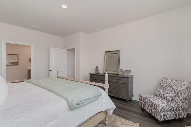 bedroom with dark wood finished floors, baseboards, and recessed lighting