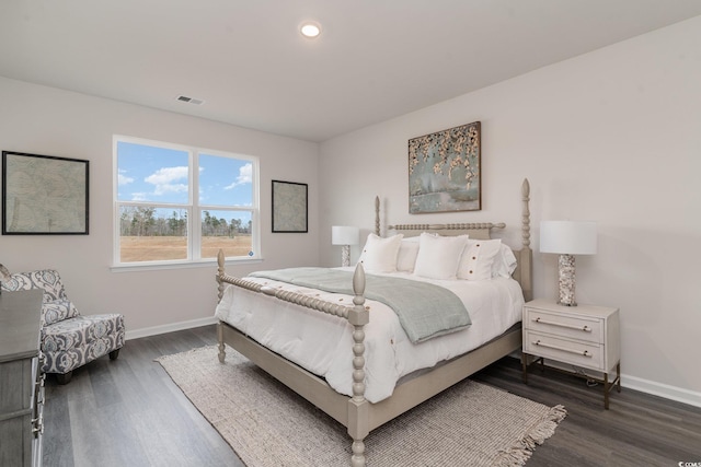 bedroom with baseboards, dark wood finished floors, and recessed lighting