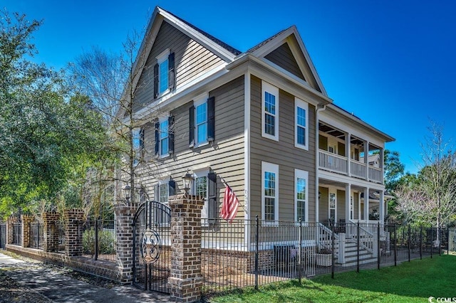 view of front of property with a balcony and a fenced front yard