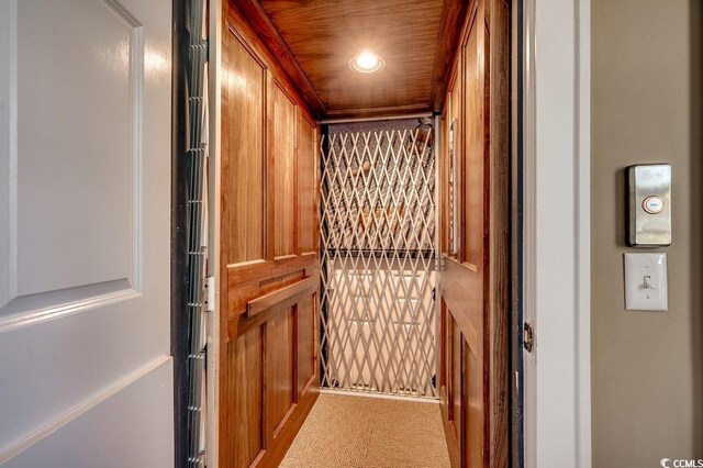 room details with carpet, wooden ceiling, elevator, and recessed lighting