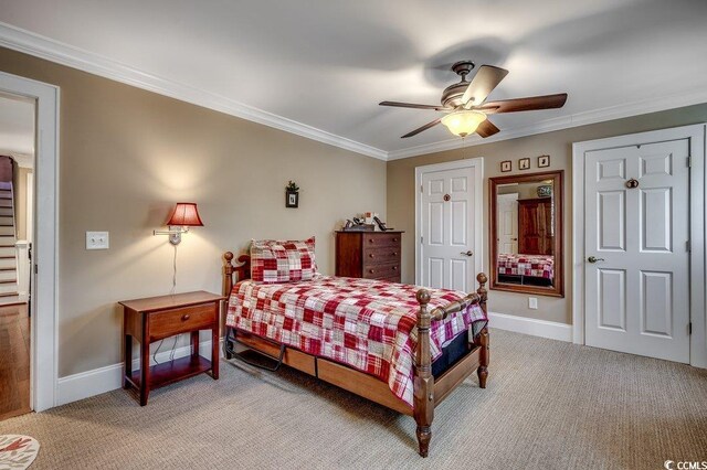 bedroom featuring light carpet, crown molding, and baseboards